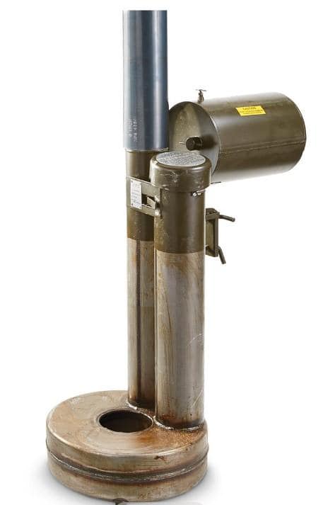 A hand reaching out to a metal barrel with water

Description automatically generated